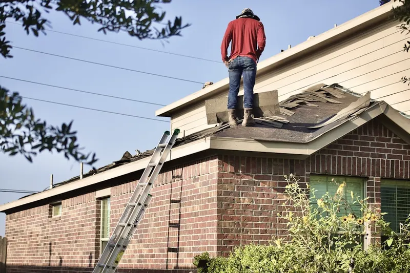 Professional roofer working on a residential roof in Finderne
